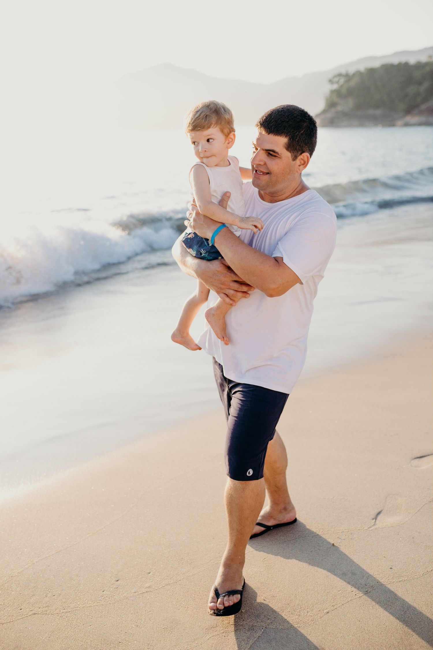 Beachside moment with waves crashing in background during sunset.