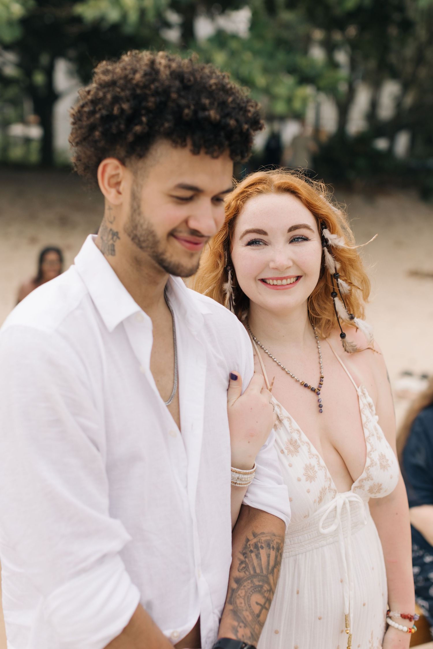 Joyful couple sharing a laugh during their casual beach wedding.