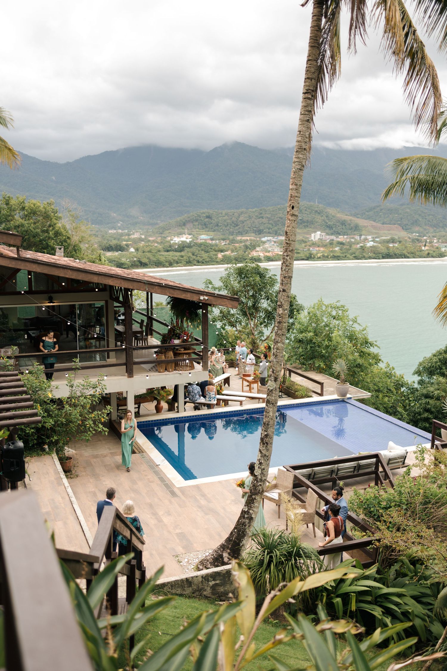 A tropical resort venue with swimming pool overlooking mountain and ocean views.