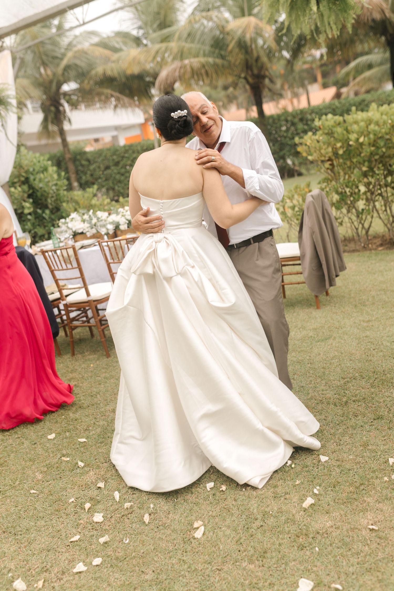 Dancing couple on a grassy venue with outdoor reception seating visible.