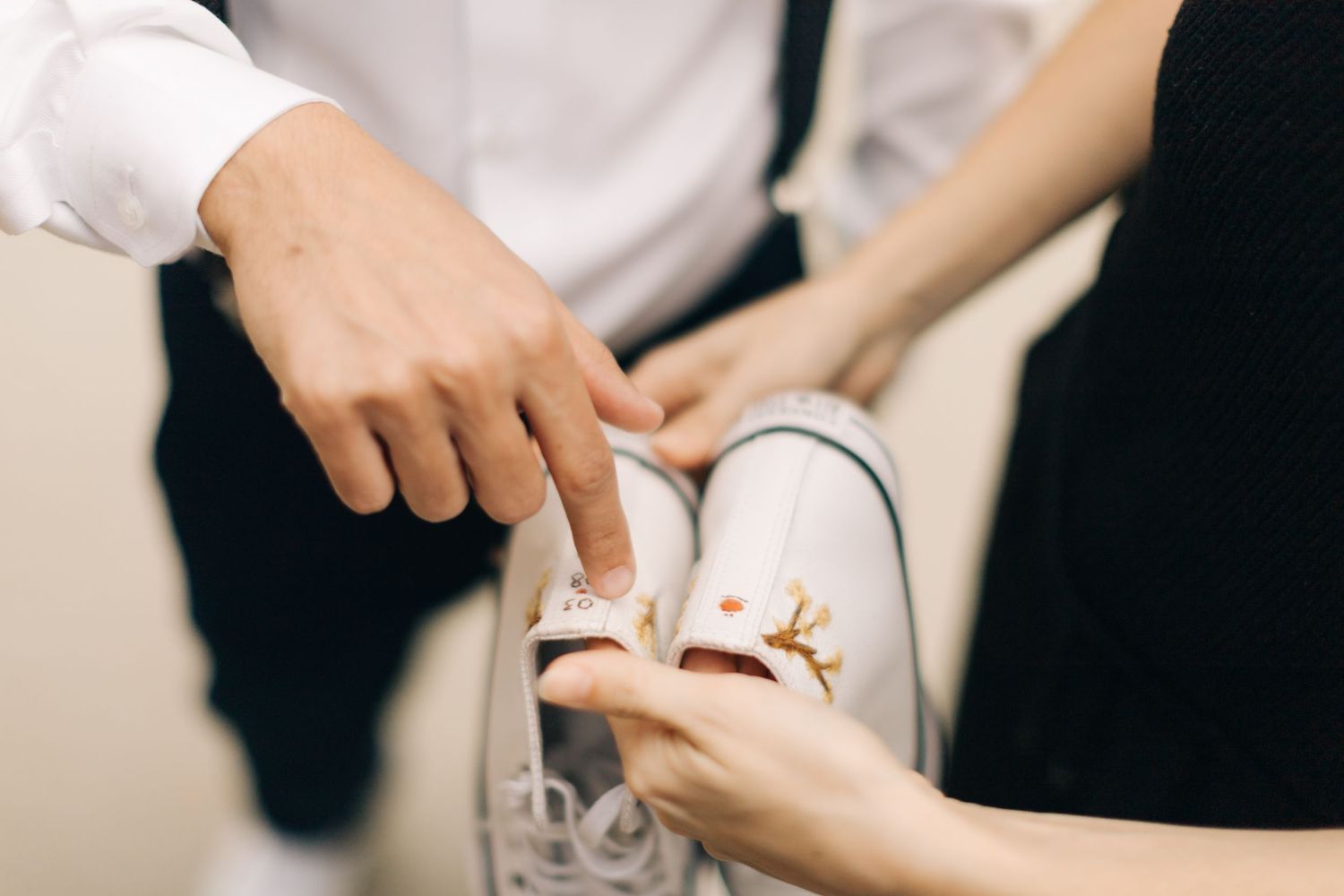 Pair of hands preparing elegant paper decorations for a wedding celebration.