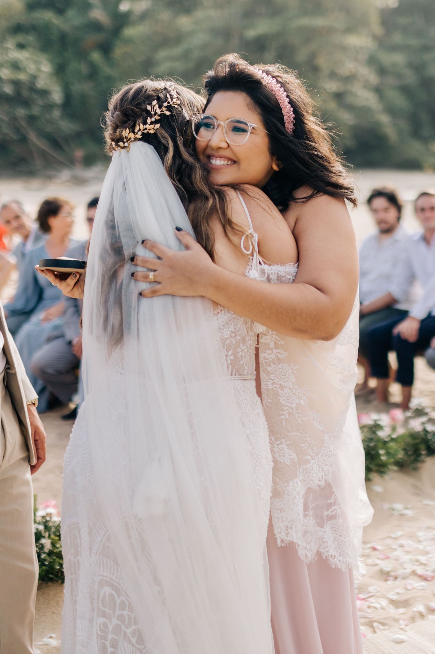 An emotional embrace during a beachside wedding ceremony.