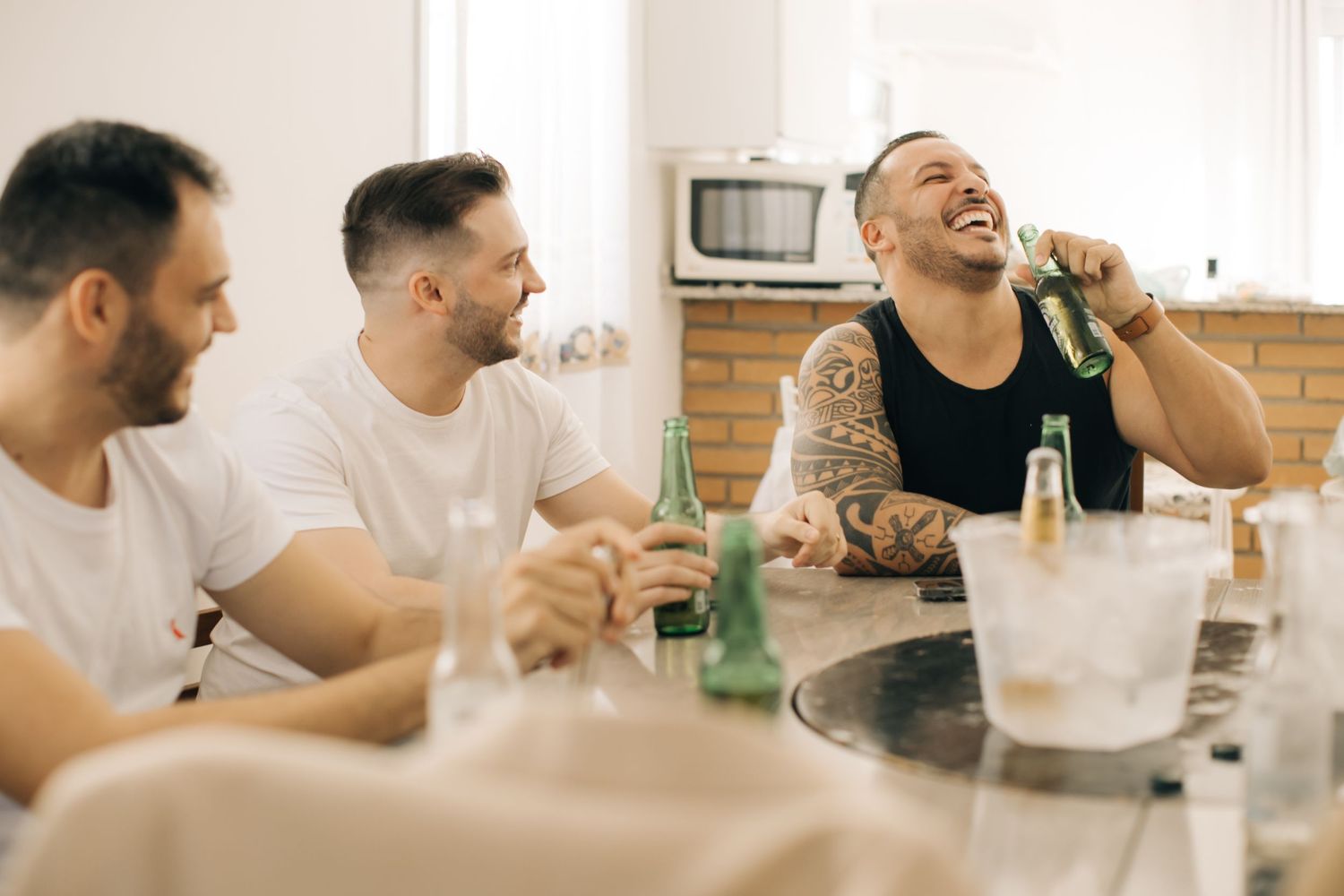 Casual gathering of people in white shirts sitting at a table.
