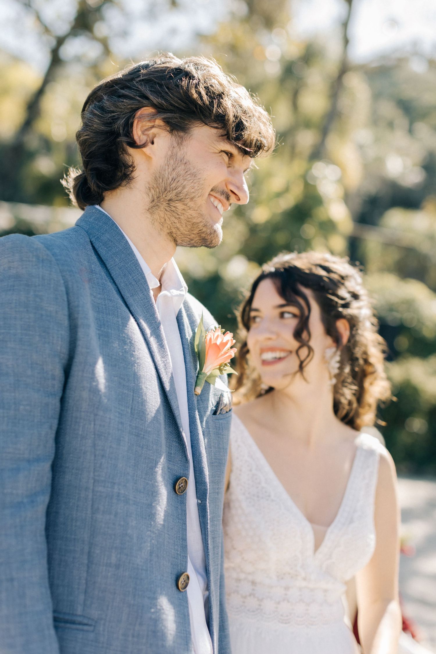 A couple shares a candid moment during their outdoor wedding ceremony.