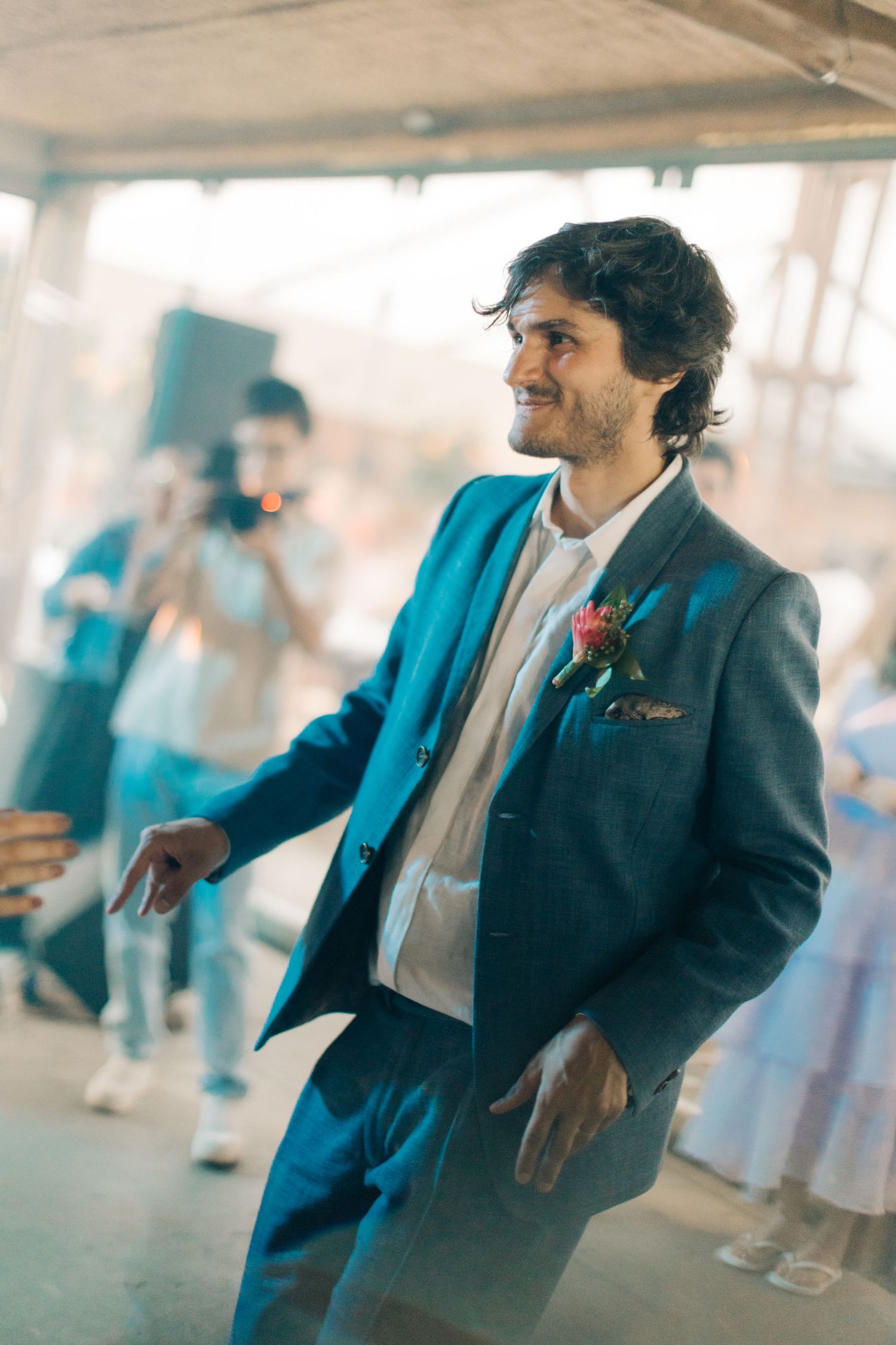 Person in blue suit jacket moving gracefully across the dance floor.