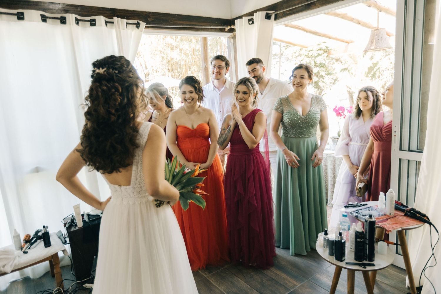 Wedding party gathering in colorful formal dresses during preparation.