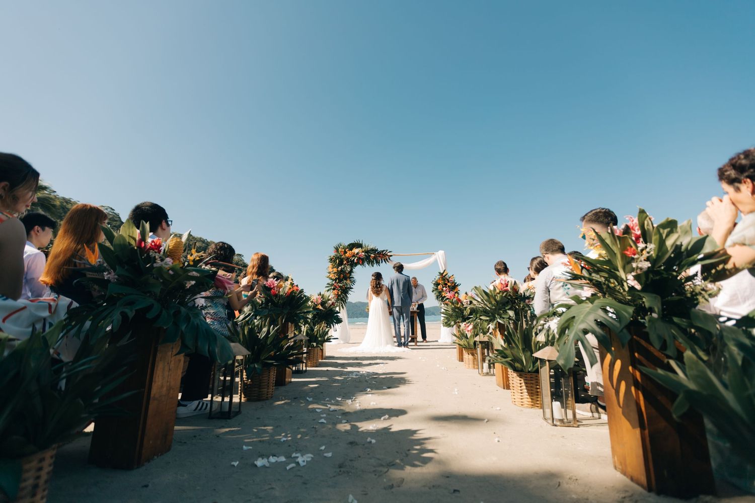 Panoramic view of an outdoor wedding ceremony setup against blue skies.