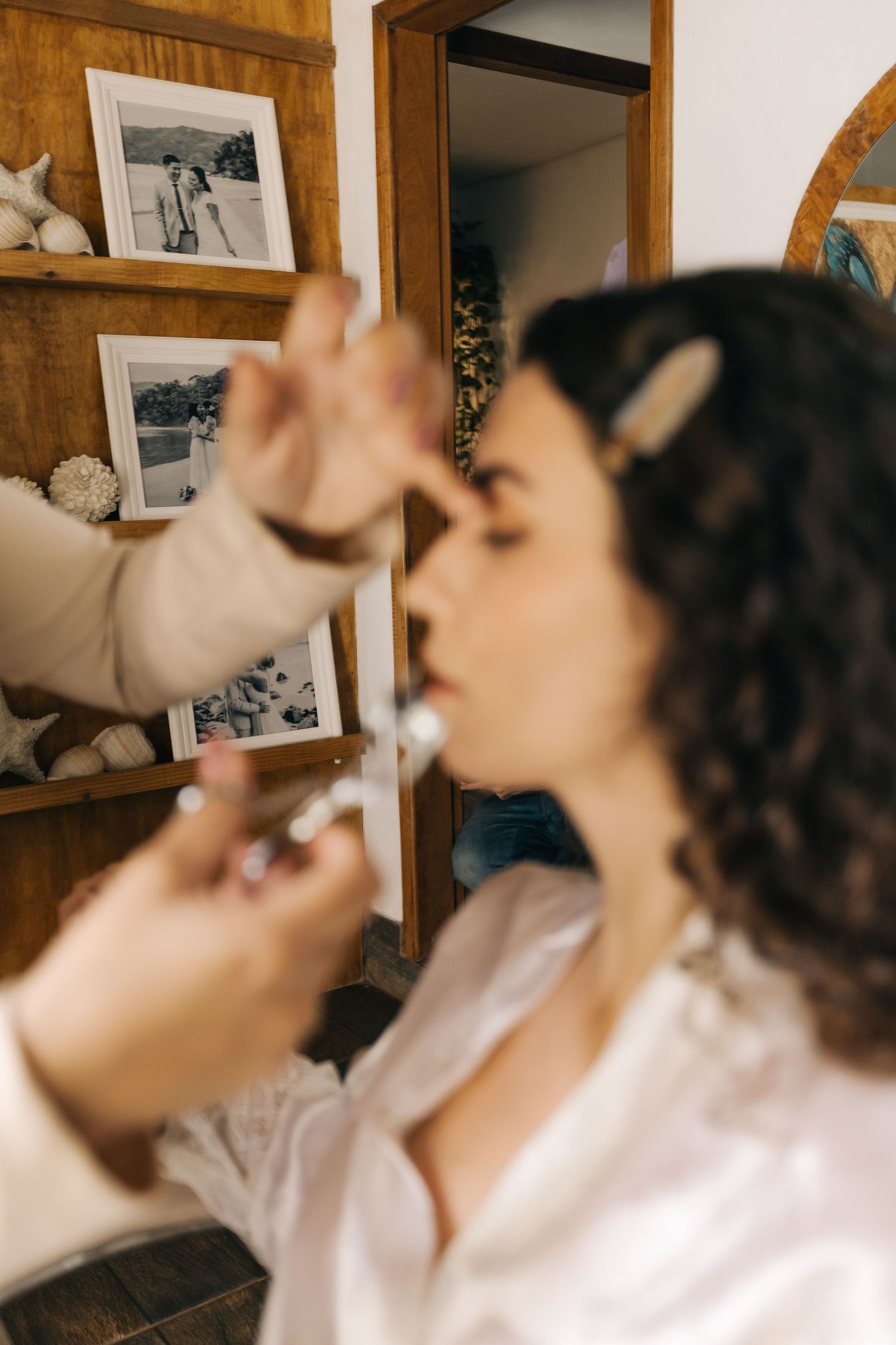 Hair and makeup preparation scene with curly-haired figure getting ready for special event.