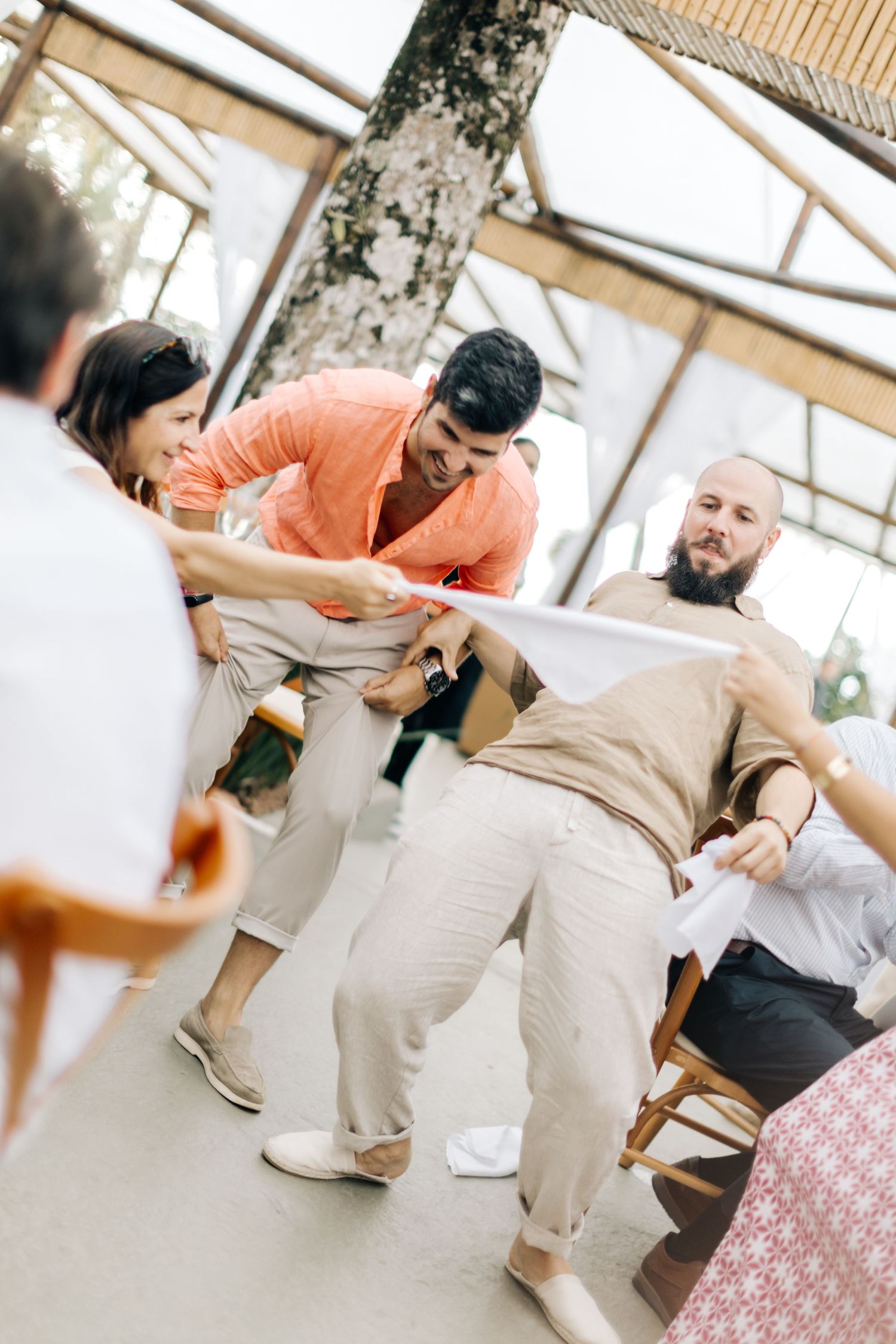 Wedding guests engage in lively party games during reception celebrations.