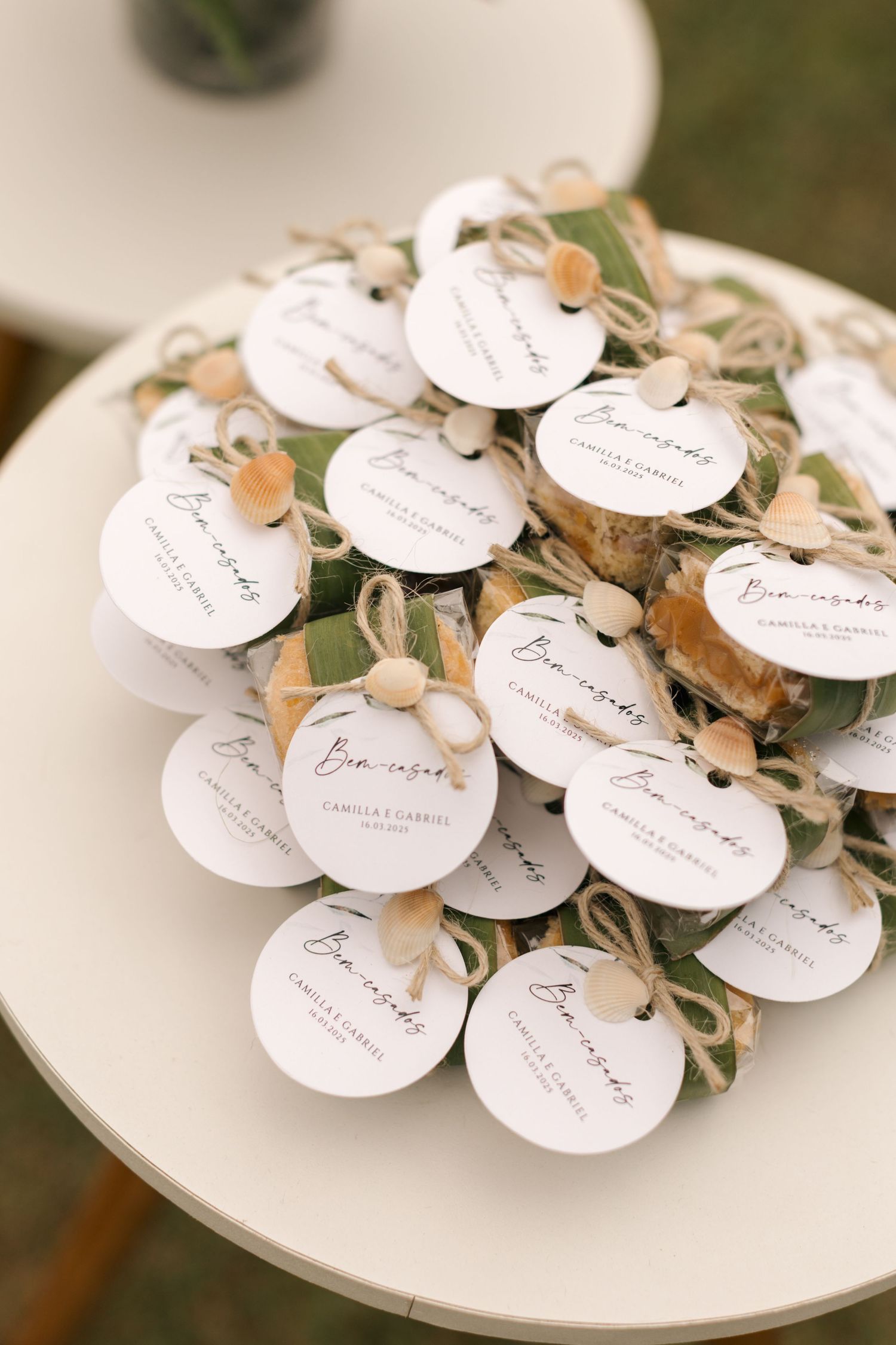 White circular name tags with delicate floral decorations arranged on a plate for wedding seating.
