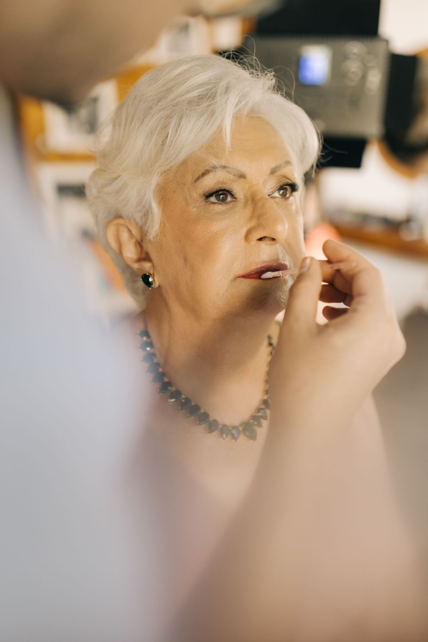 Close-up profile shots showing elegant makeup and jewelry details.