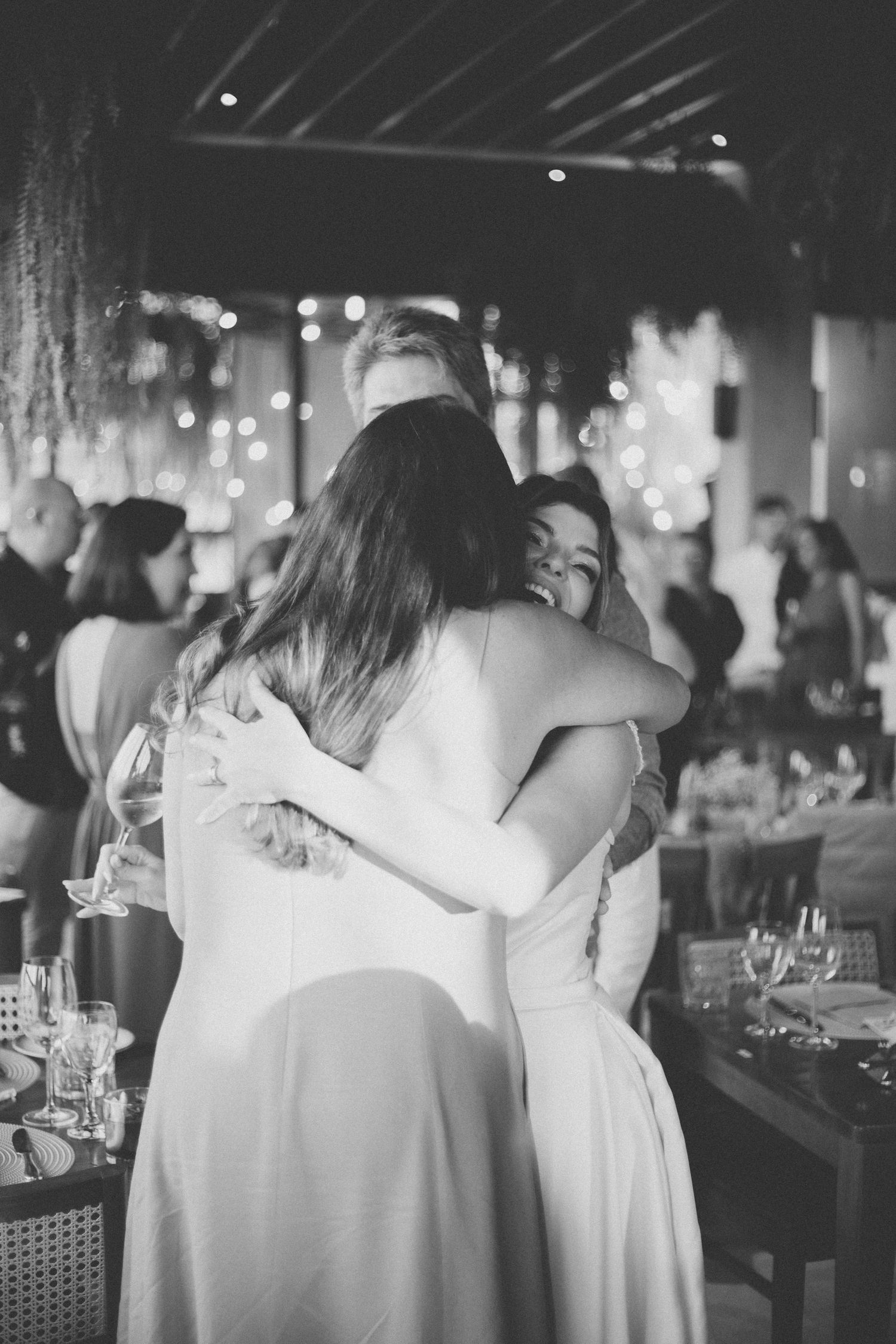 Black and white reception photos capturing intimate moments between wedding guests.