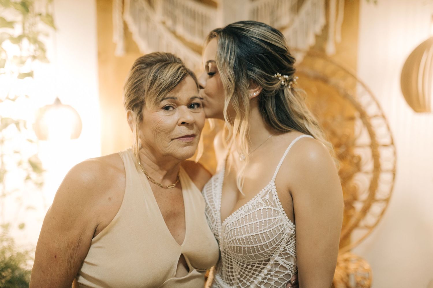 Intimate moment captured during wedding celebration with elegant dress contrast.