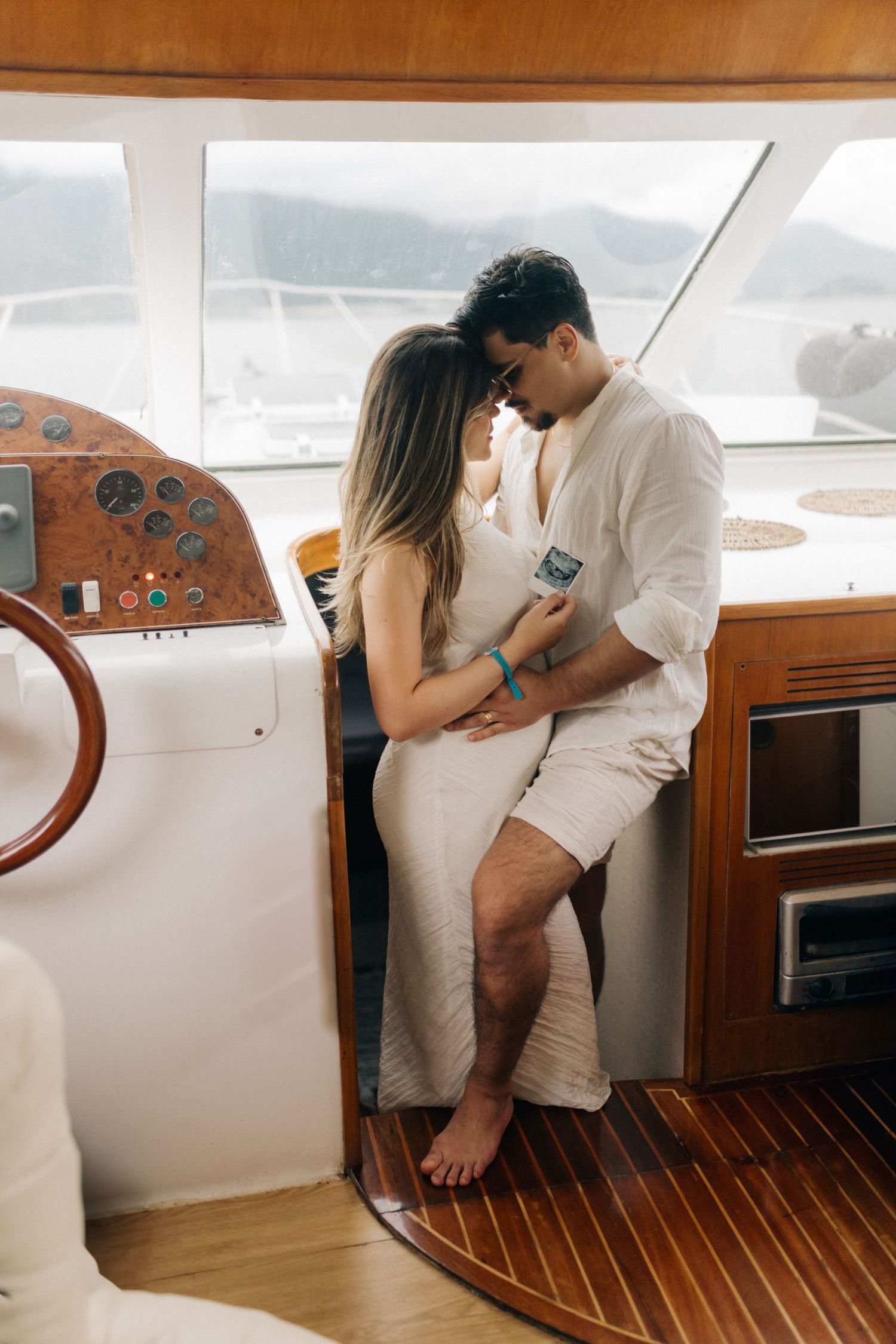 A romantic scene inside a yacht's cabin with wooden interior details.