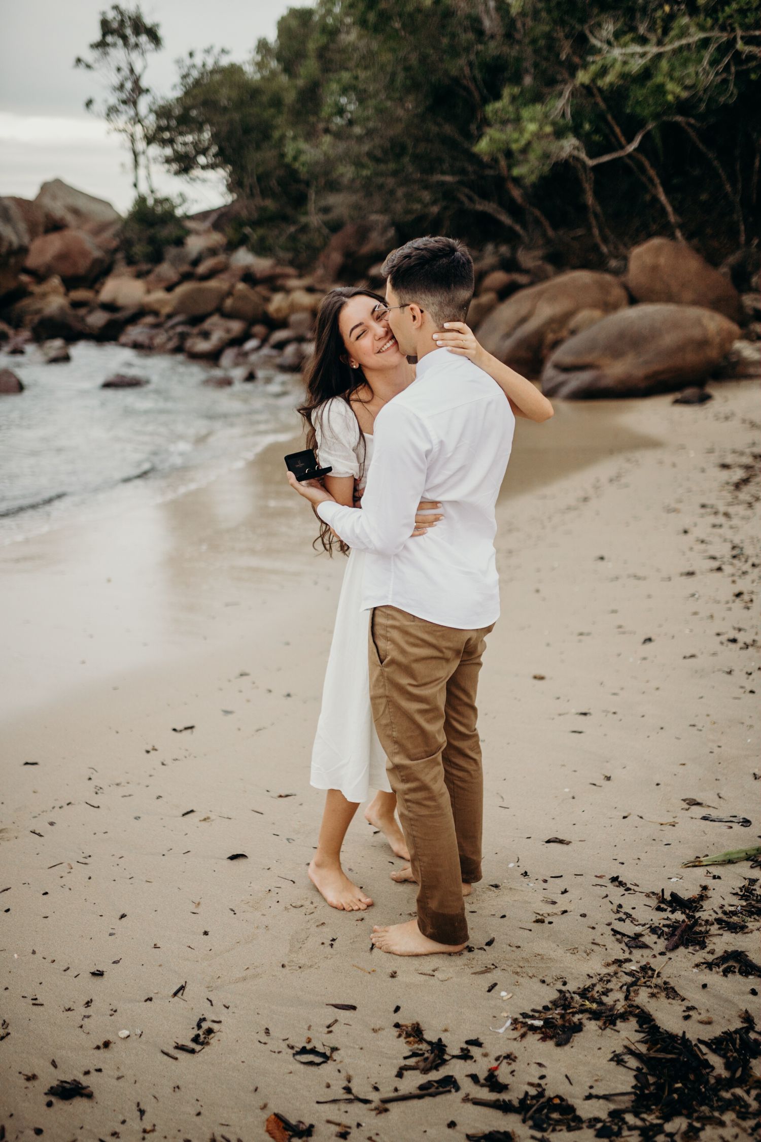 Emotional proposal photography sequence on secluded beach.