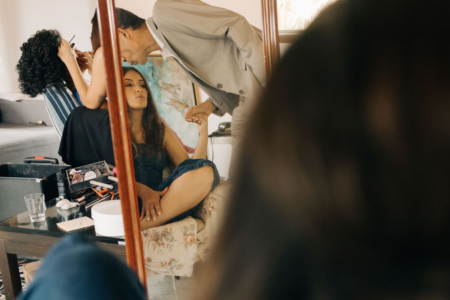 Behind the scenes view of beauty preparation with styling tools and mirror.