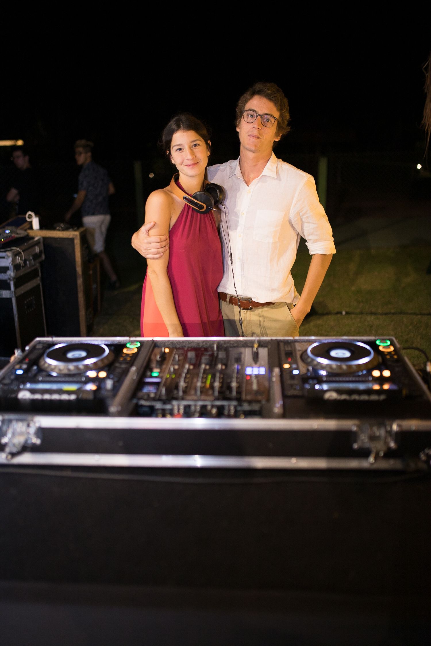 DJ setup with professional equipment at outdoor nighttime wedding reception.