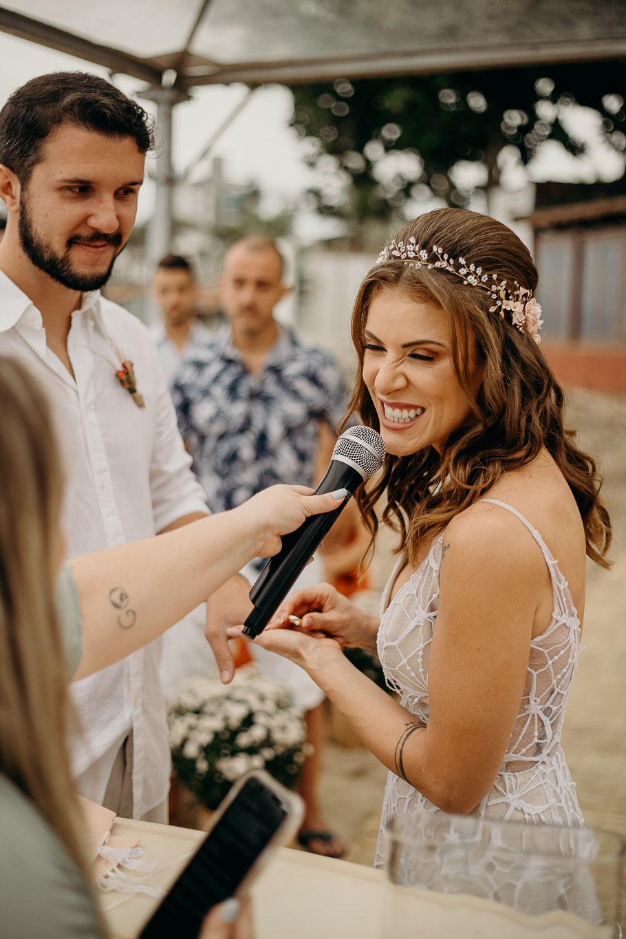 Joyful celebration moments captured at outdoor beach wedding with string lights.