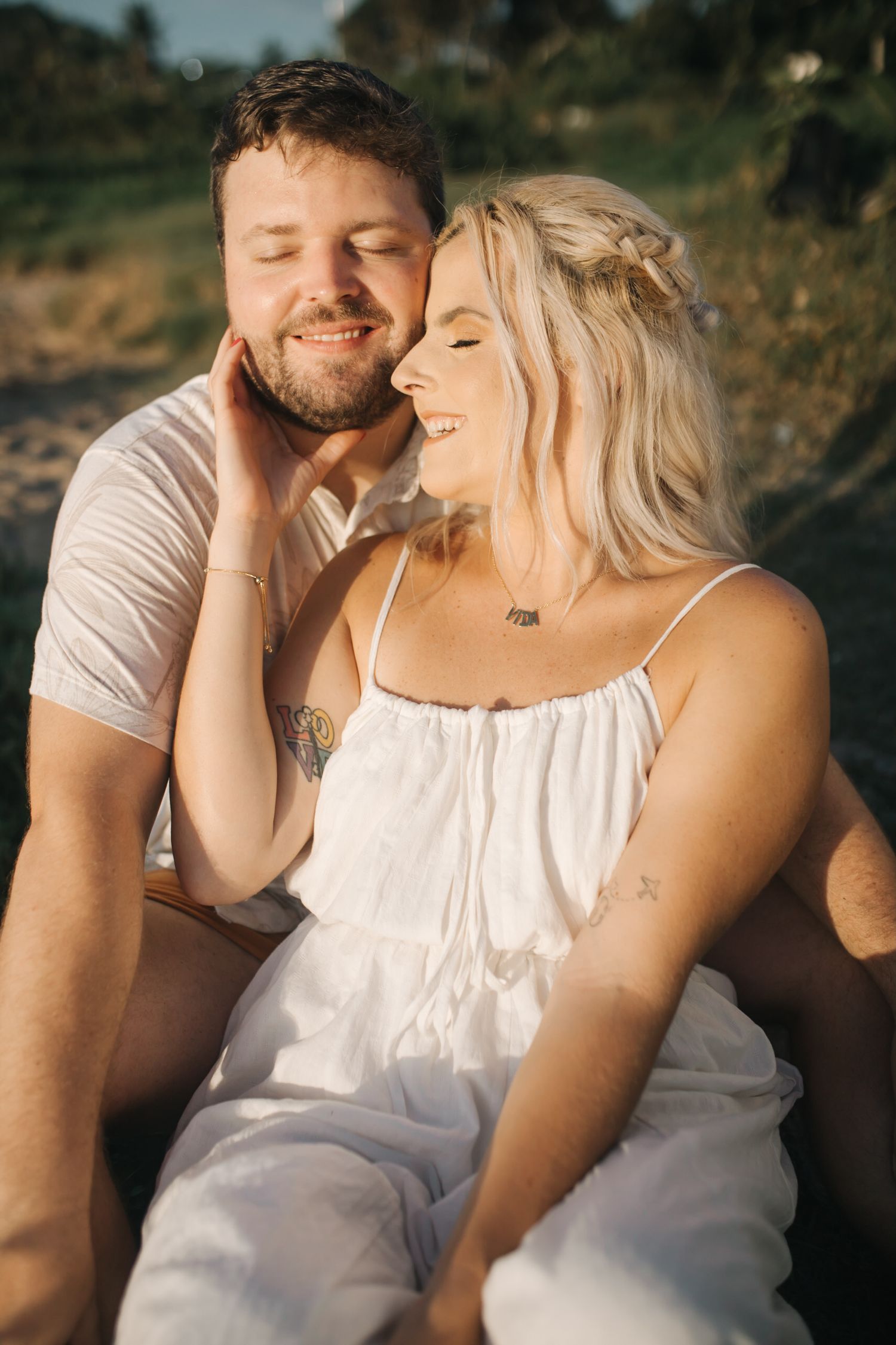 A candid moment of shared laughter during a sunset photo session outdoors.