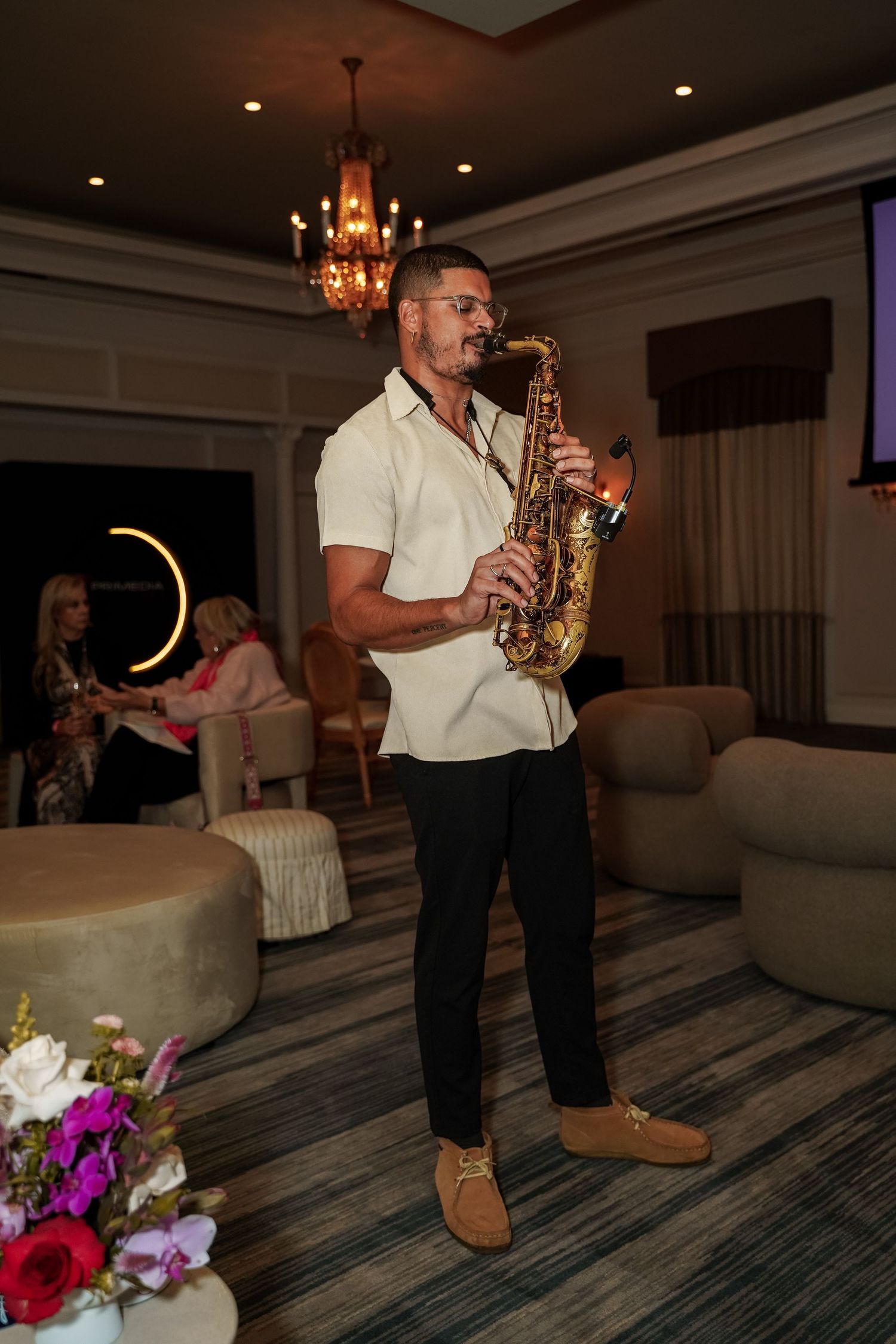 Saxophonist performing live music in elegant venue at Primedia Cares corporate event.