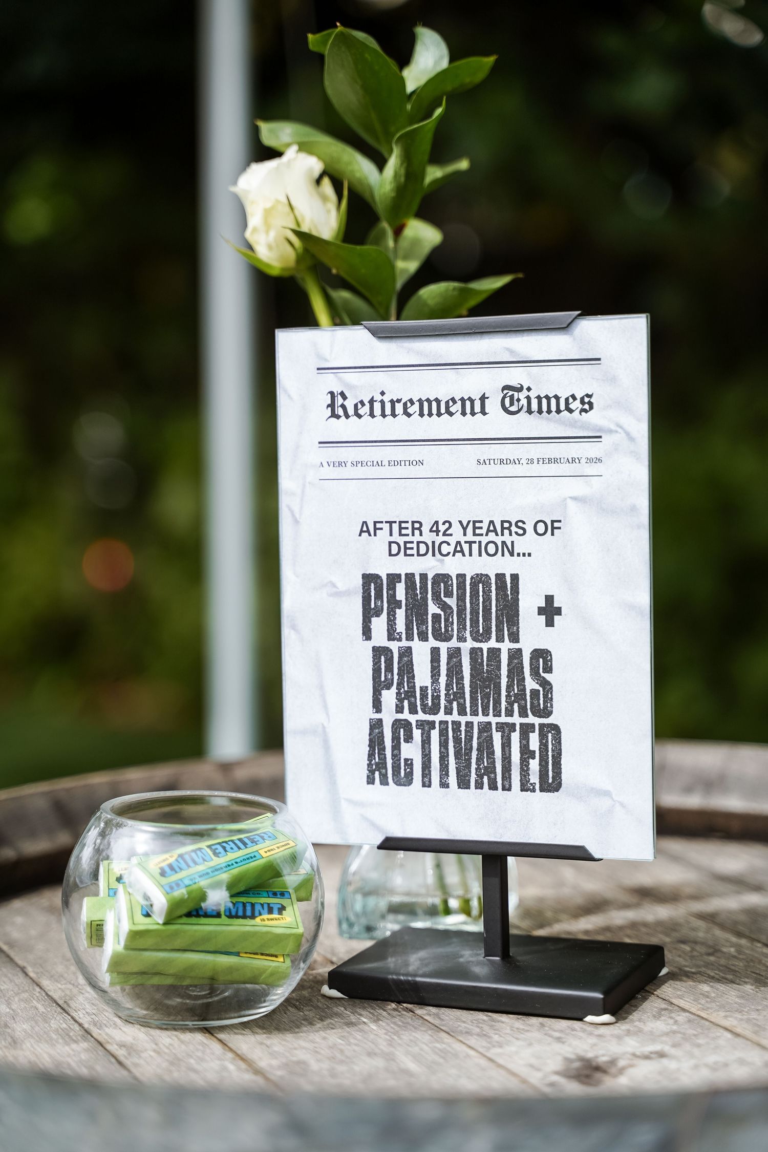 Retirement party sign reading Pension and Pajamas Activated after 42 years.
