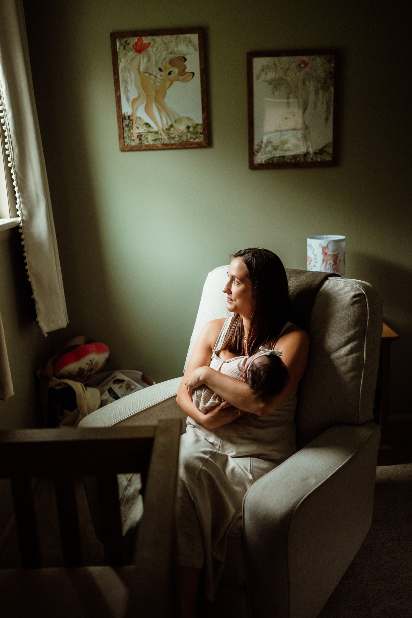 Mom kissing newborn on forehead in nursery, Phoenixville, PA newborn photographer