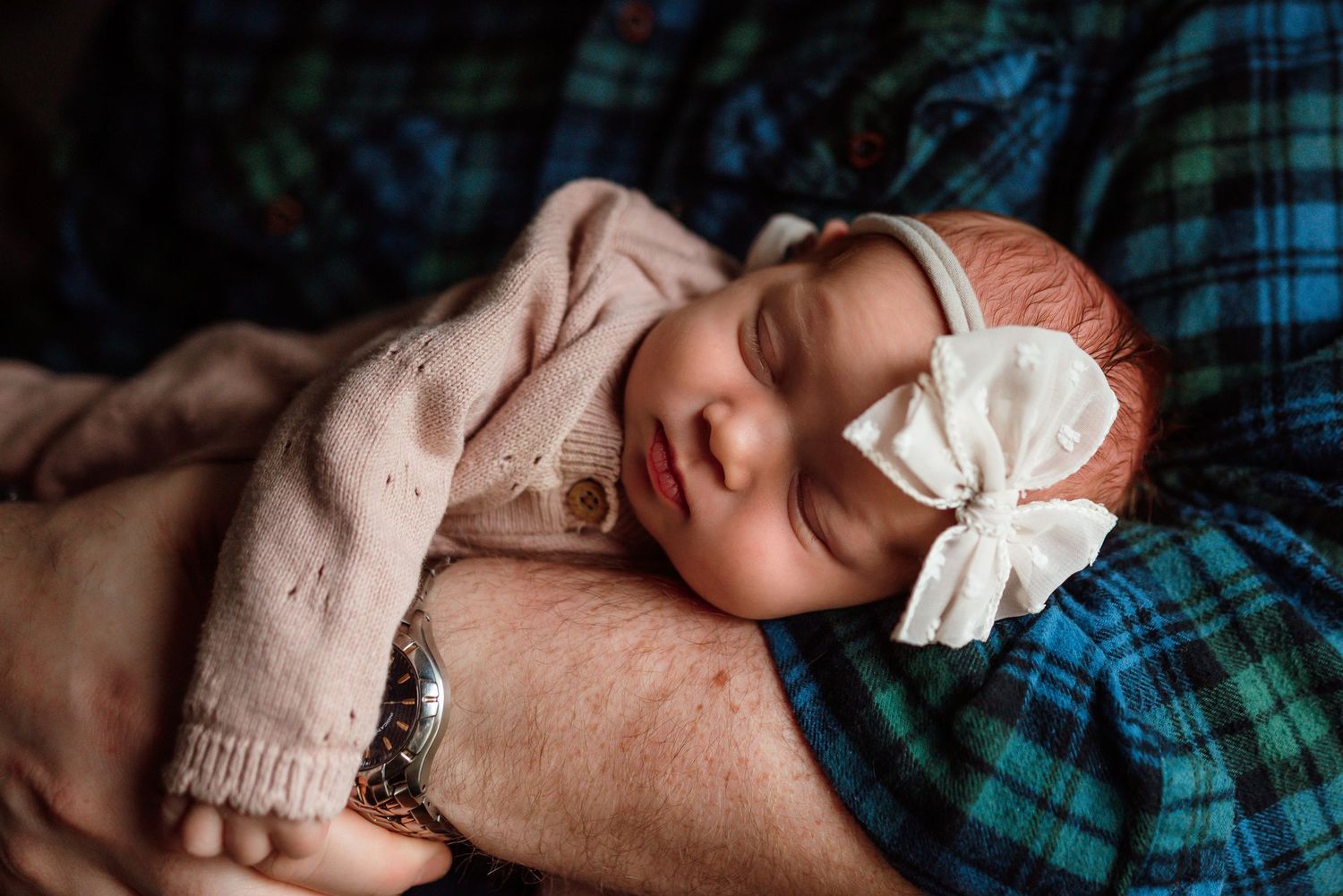 baby cozied up with her dad in an in-home session in Phoenixville, PA