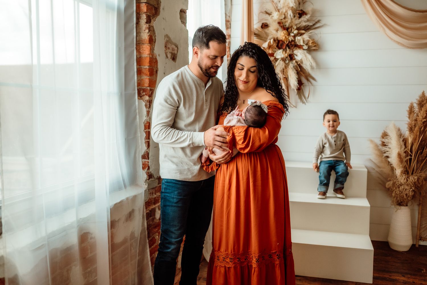 Mom and dad and baby playing together, candid family portraits, Phoenixville PA