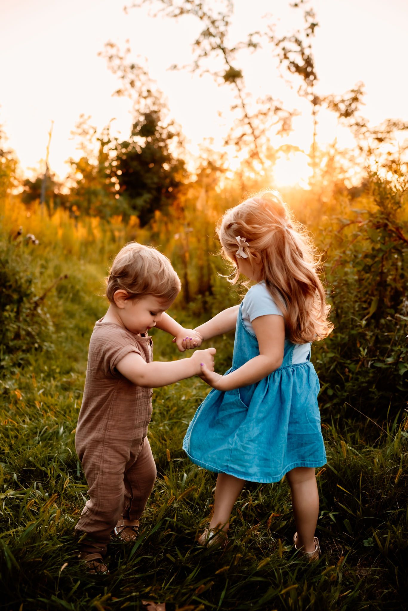 Two siblings holding hands walking, outdoor family photography near Philadelphia