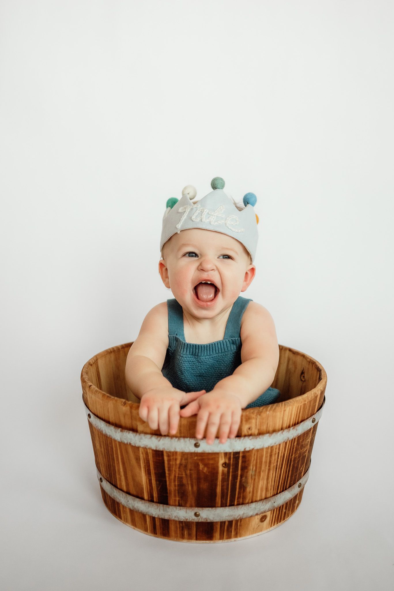 Toddler blowing out birthday candles, one year milestone session, Harleysville PA