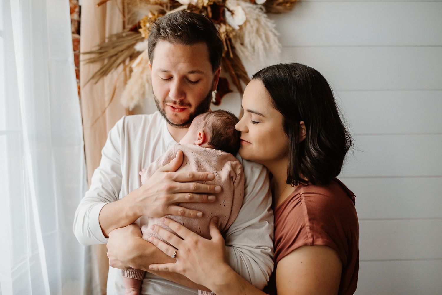 Newborn baby yawning in parent's arms, Phoenixville, PA newborn photography
