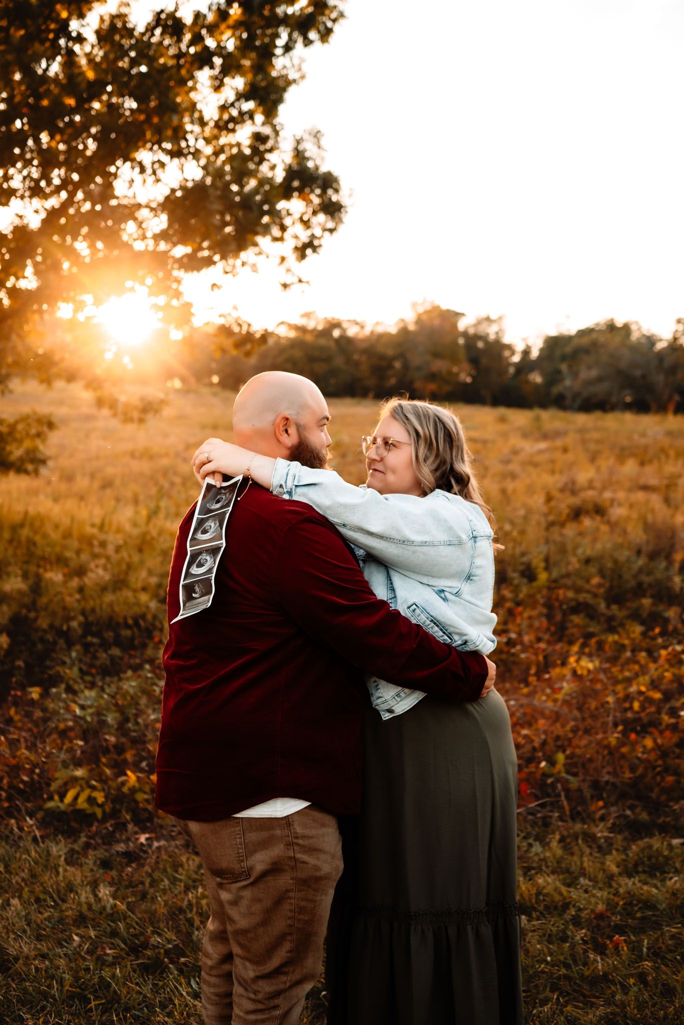 Couple holding ultrasound images, outdoor pregnancy announcement session, Phoenixville PA