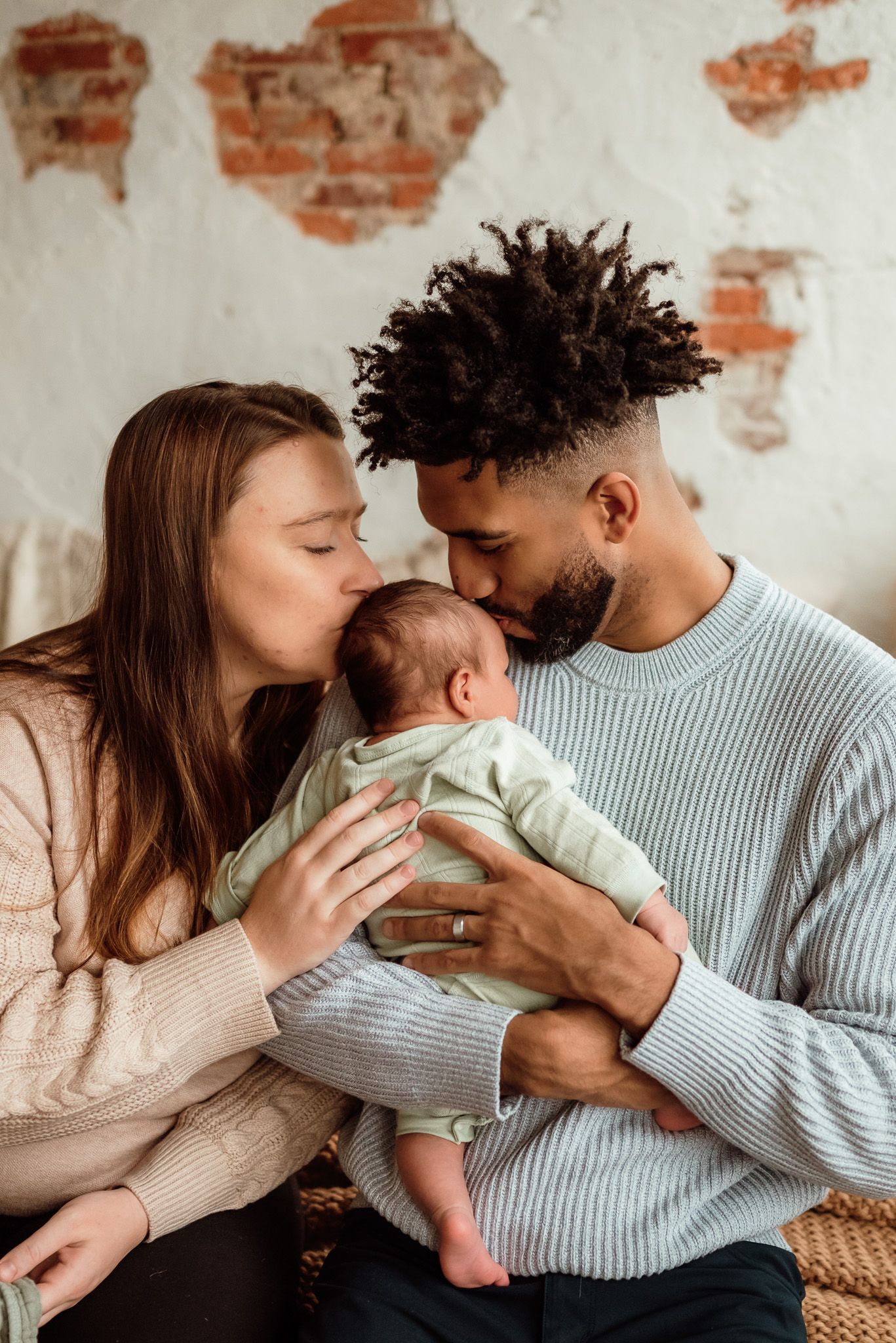 Couple cuddling and tenderely holding their newborn, emotional newborn portrait, Phoenixville, PA