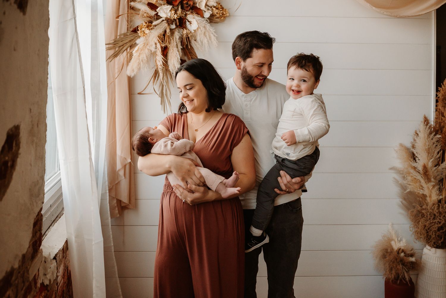 Mom and dad and baby playing together, candid family portraits, Phoenixville PA