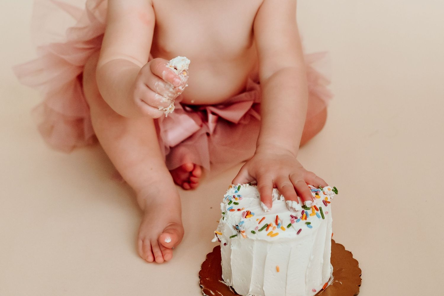 Baby girl in pink tutu during cake smash session, Collegeville PA milestone photographer