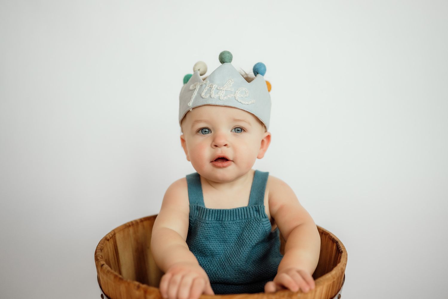Toddler blowing out birthday candles, one year milestone session, Harleysville PA