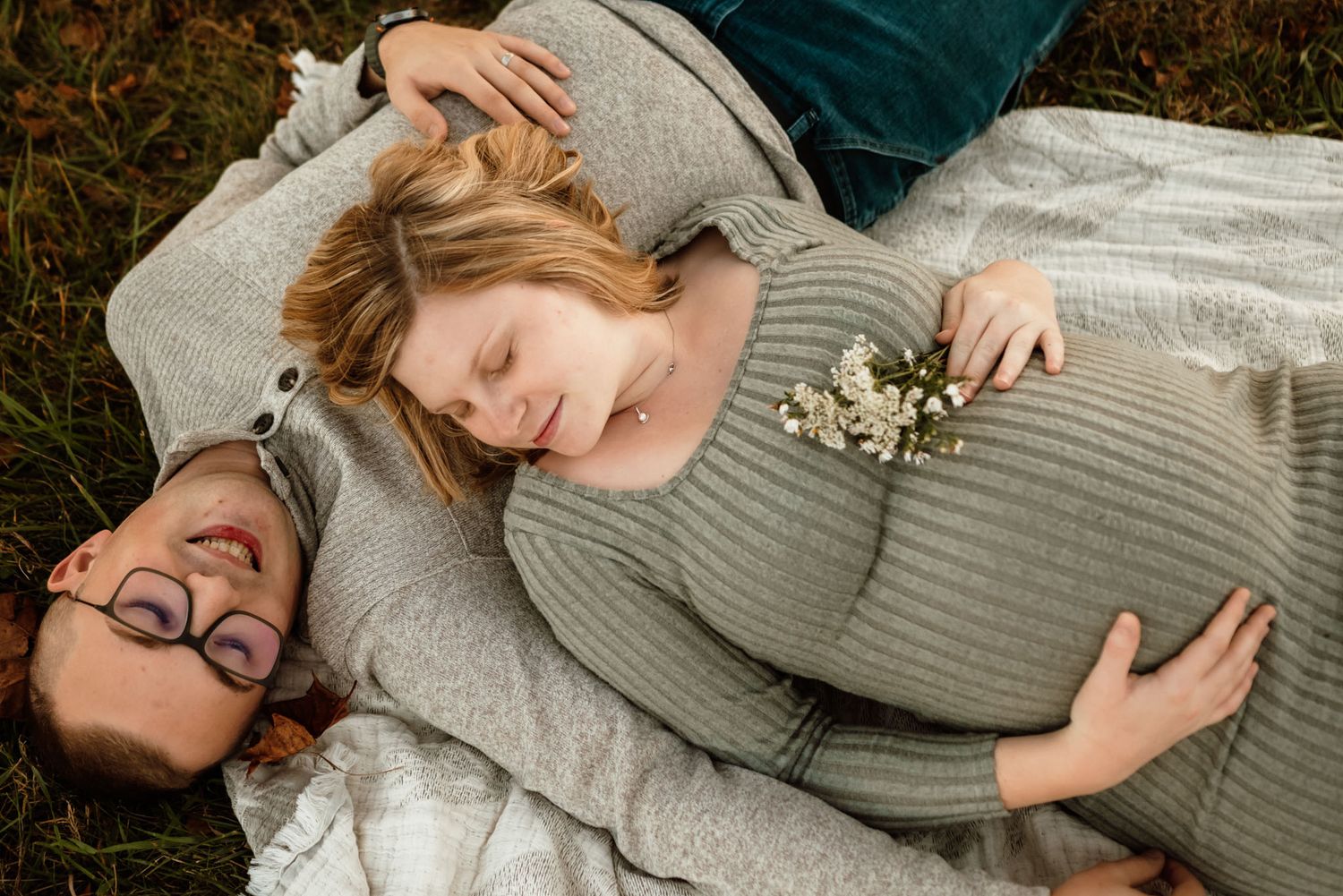 Couple kissing during maternity portraits, golden hour photography, Collegeville PA