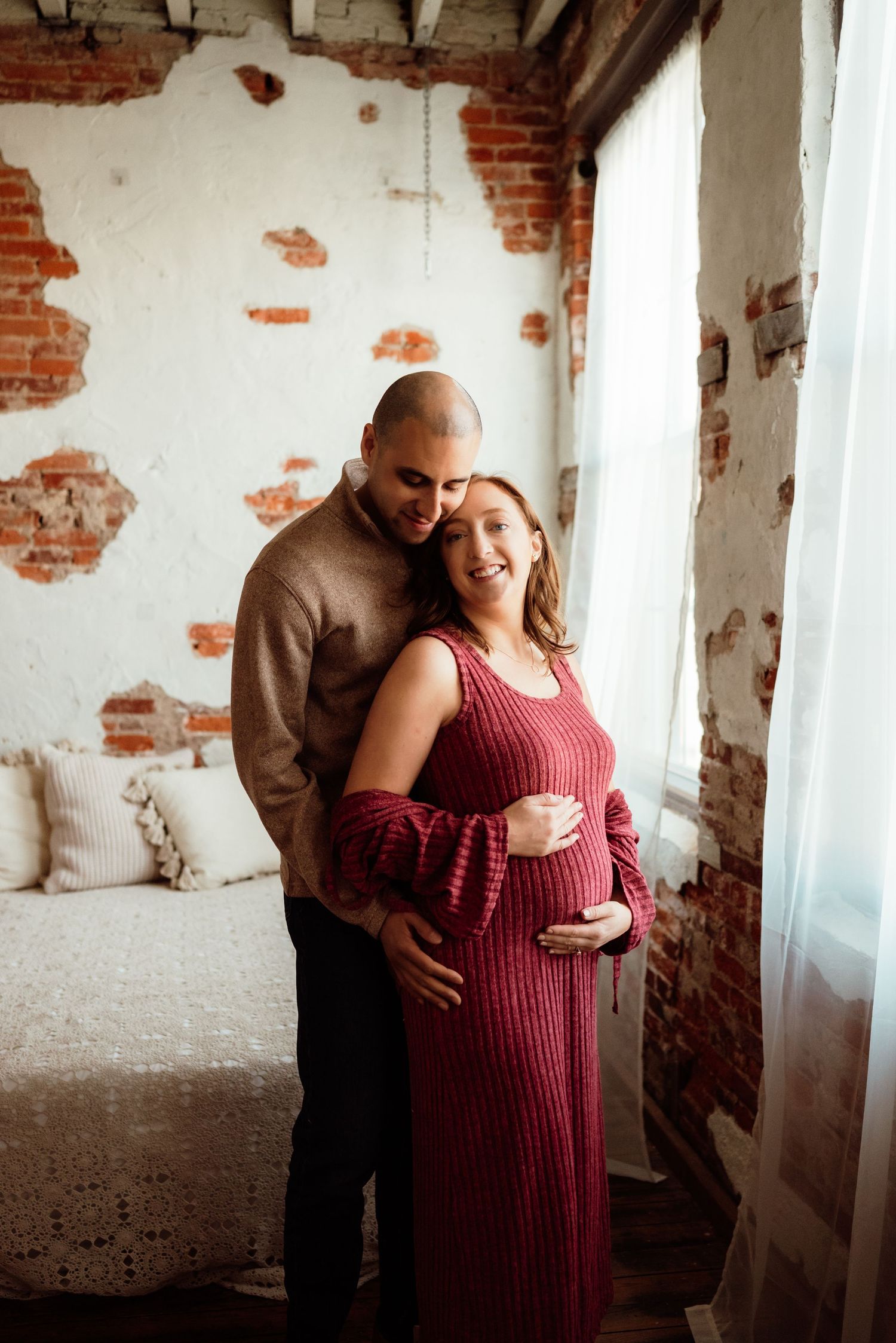 beautiful mom-to-be cradling belly in studio in philadelphia