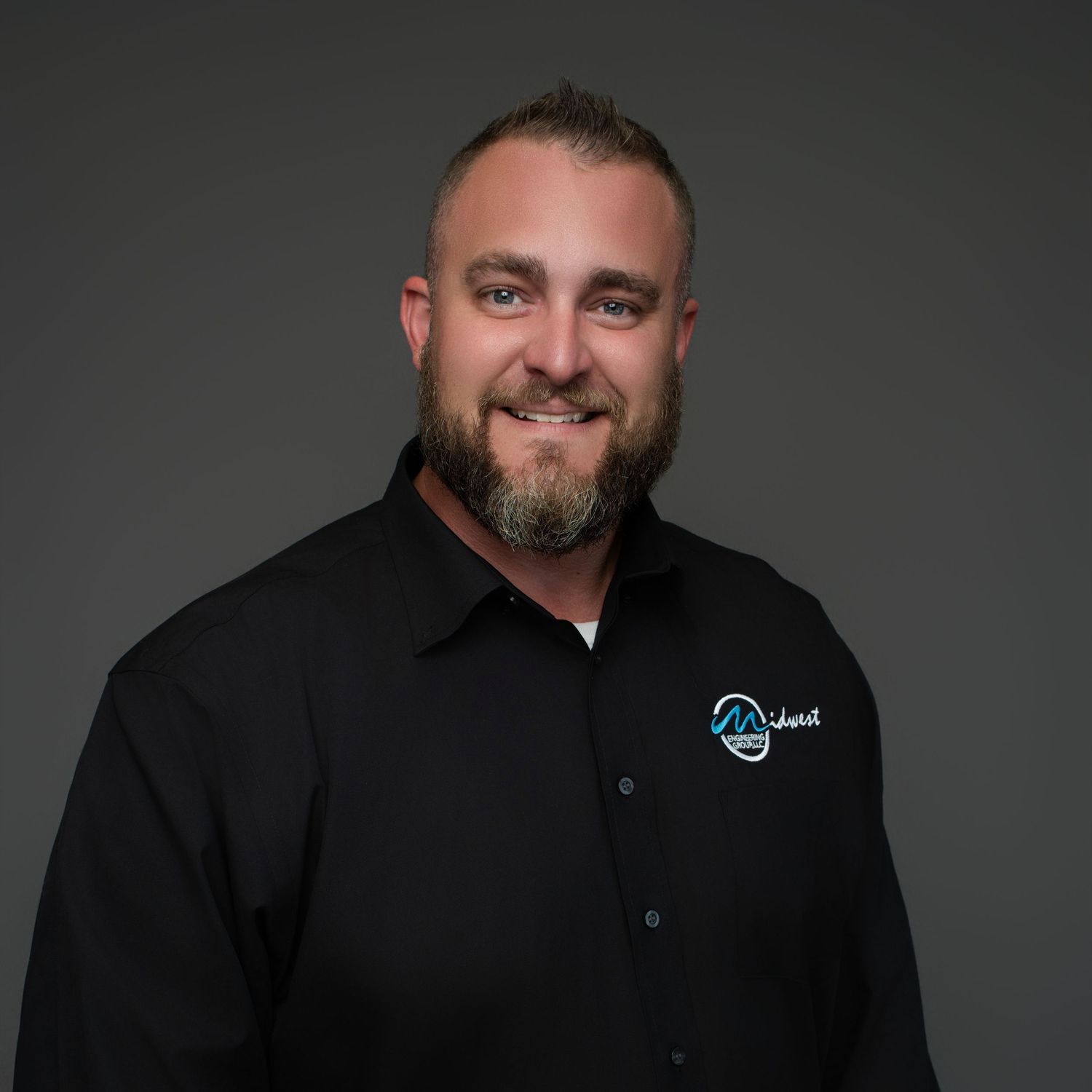 Professional headshot series of man in black shirt against dark background.