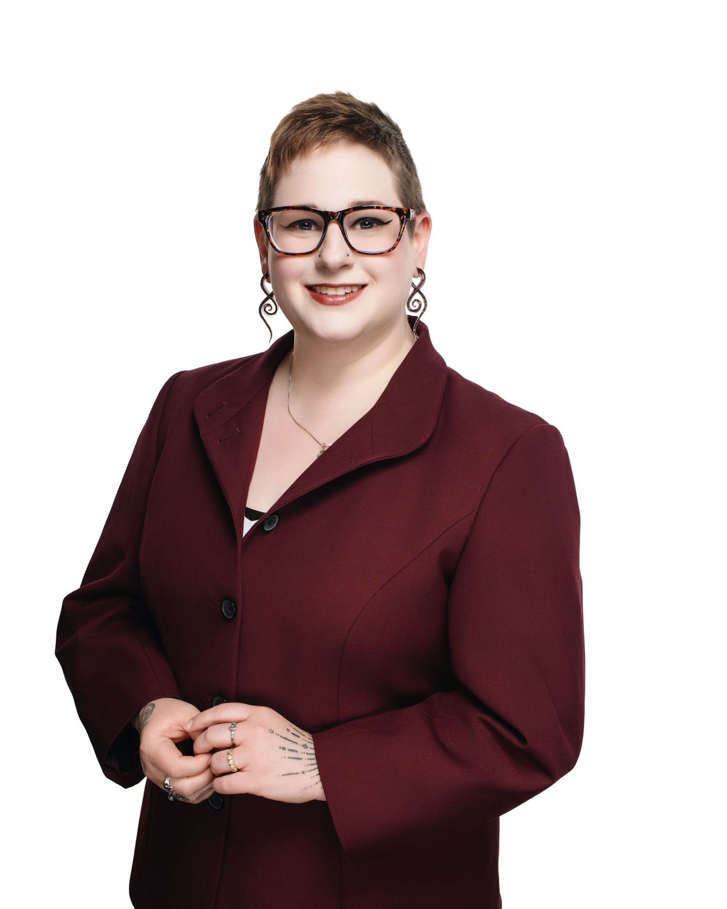 Professional portrait series in burgundy blazer against white background.