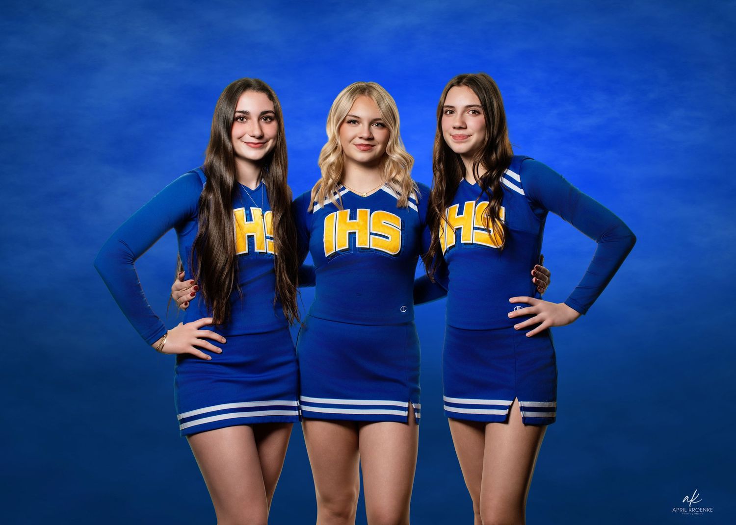 Cheerleaders in blue uniforms pose for team photos against a bright blue background.