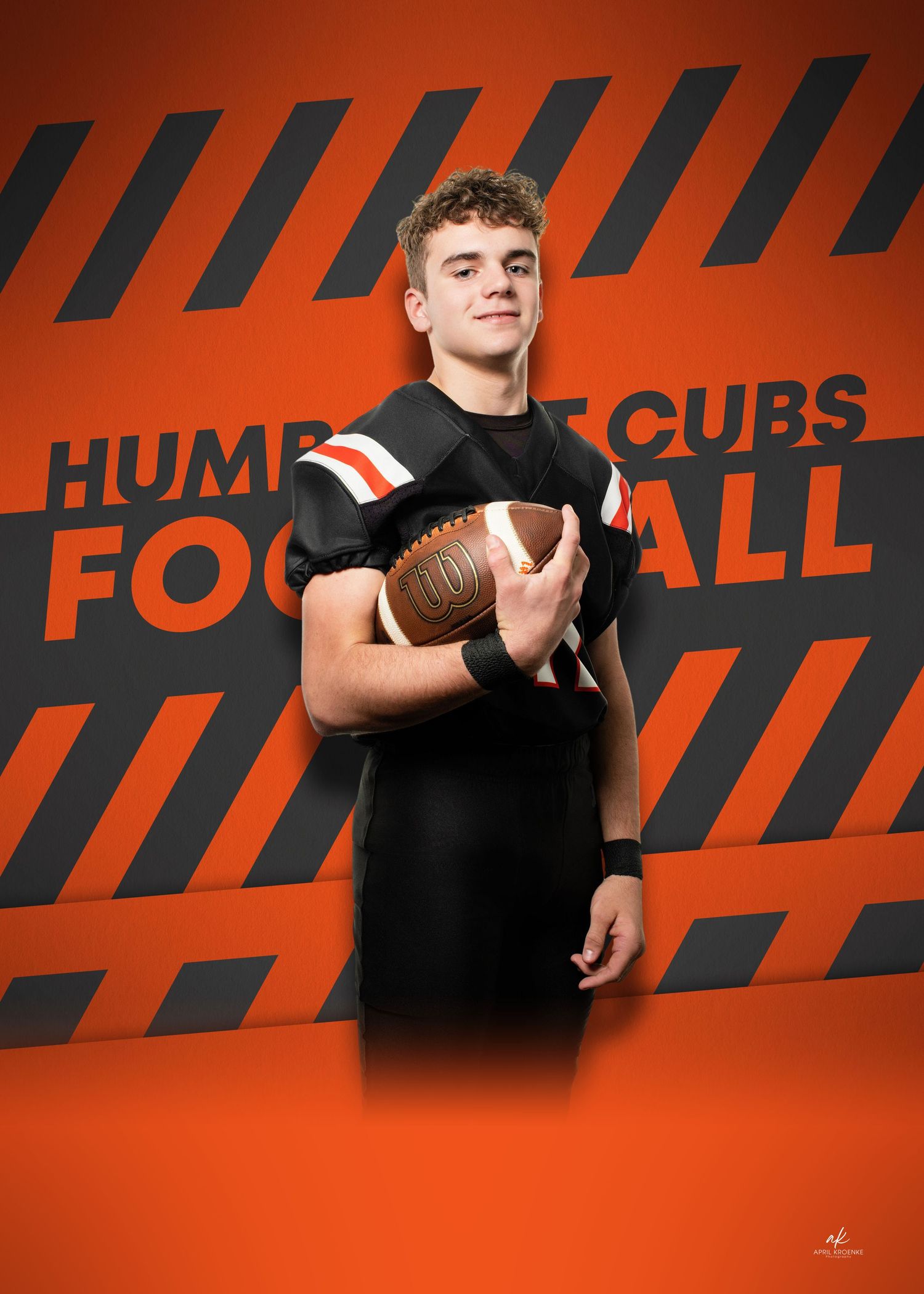 Football players in black jerseys photographed against orange and black striped background.