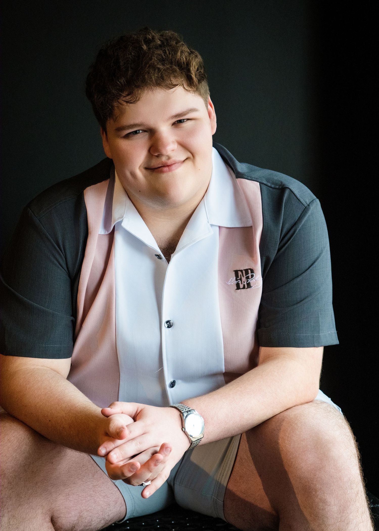 A series of four photos showing someone wearing a white polo shirt sitting with hands clasped in different poses.