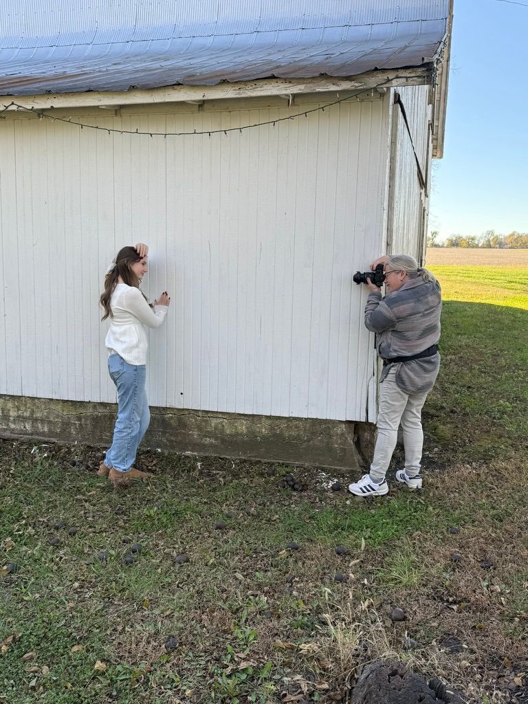 People inspecting and examining the exterior foundation of a white building.