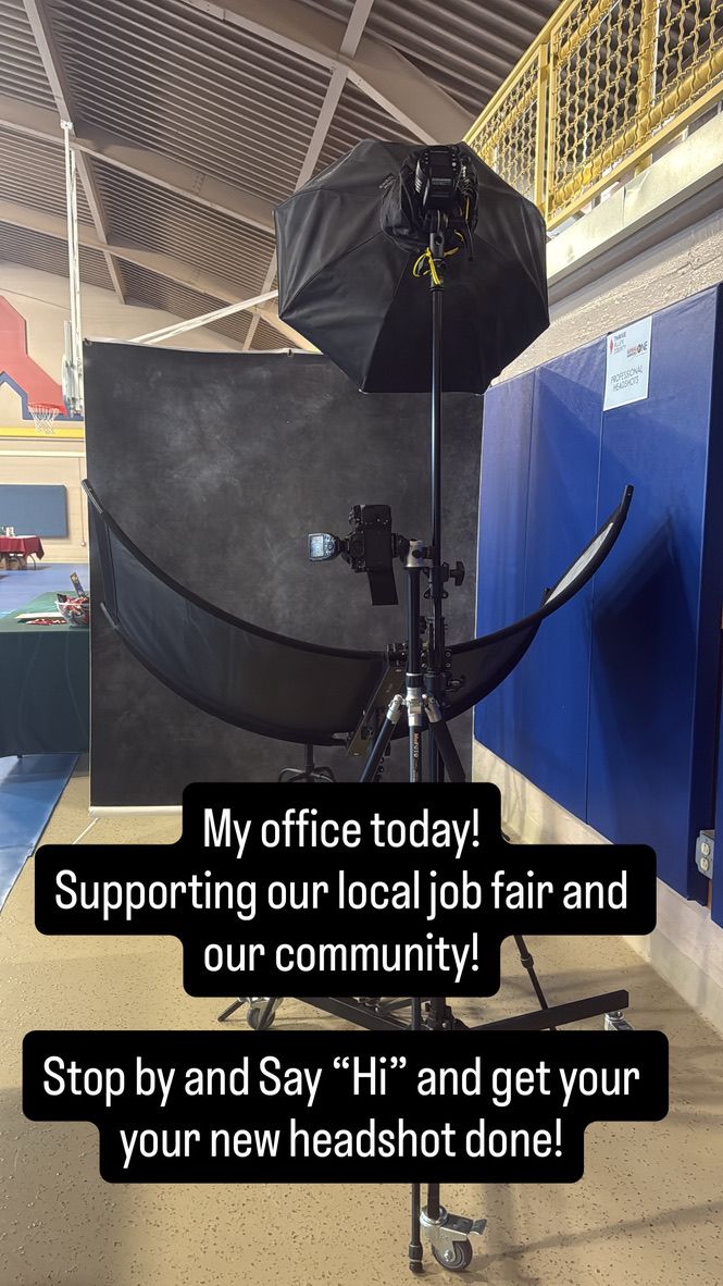 Professional photography setup with black reflector umbrellas and lighting equipment arranged in a studio space.