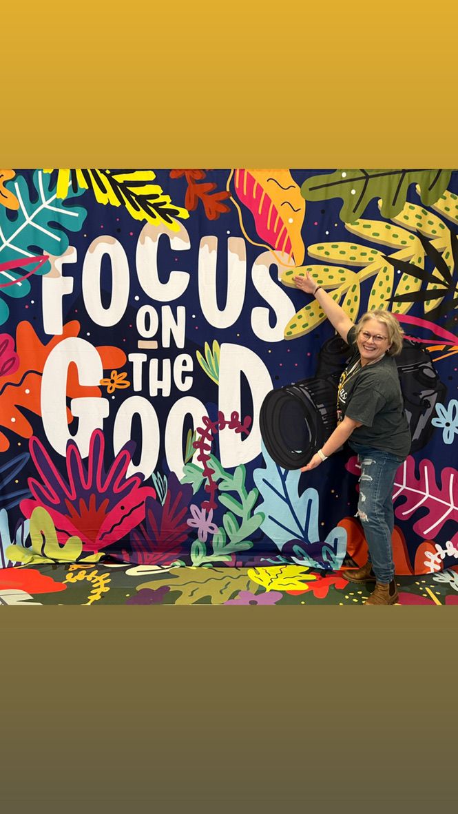 Colorful mural art installation with vibrant tropical leaves and text reading 'FOCUS ON US' against a yellow background.