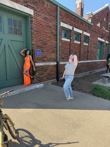 Four sequential photos show someone demonstrating how to open a heavy green door on a brick building exterior.