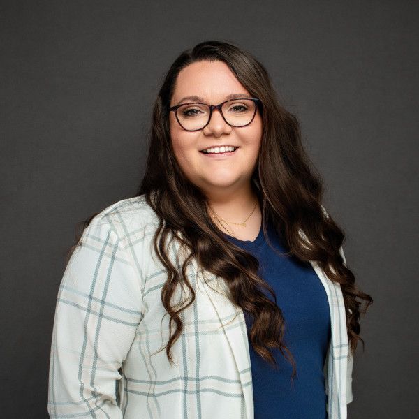 Professional headshots of someone in glasses and a white jacket against a dark background.
