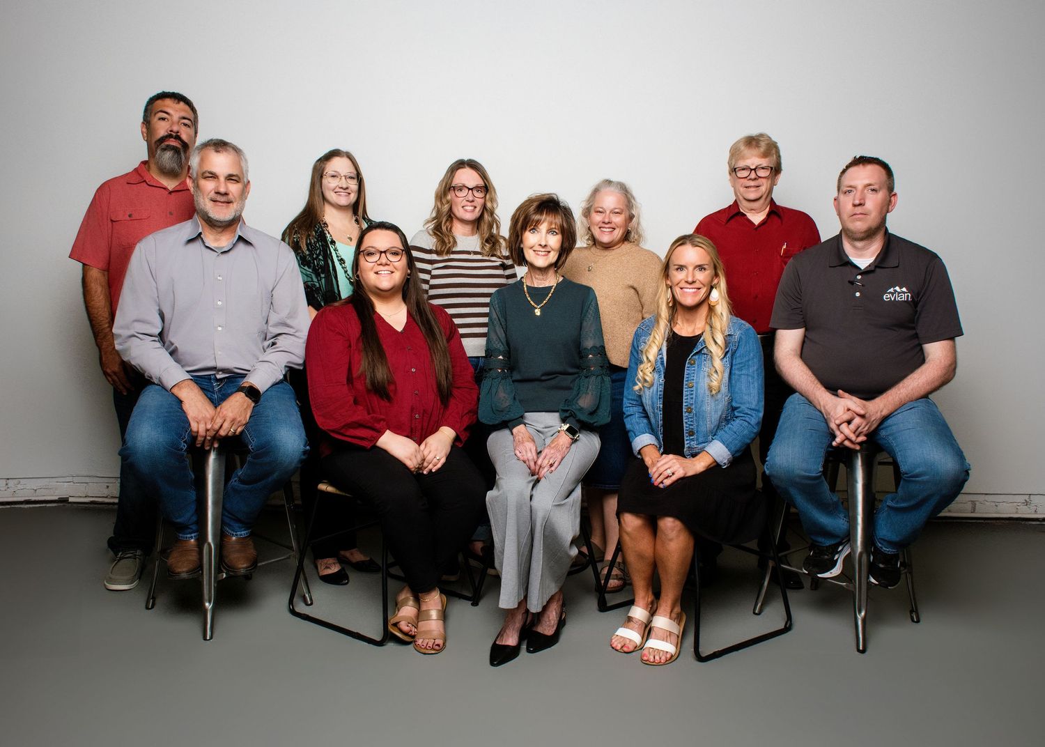 Group photo of people seated together against a white background.