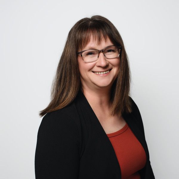 Professional headshots featuring someone in a black blazer and red top.